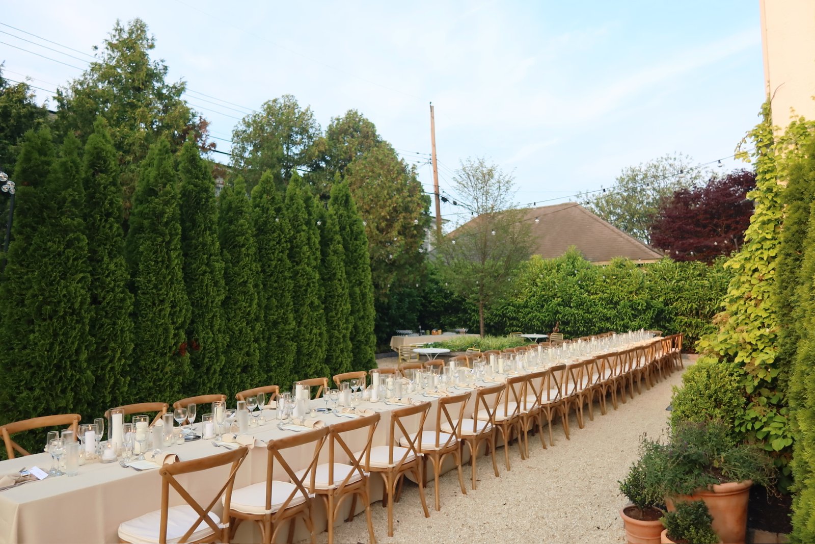 Rehearsal dinner setup on the porch with candlelit details and composed design.